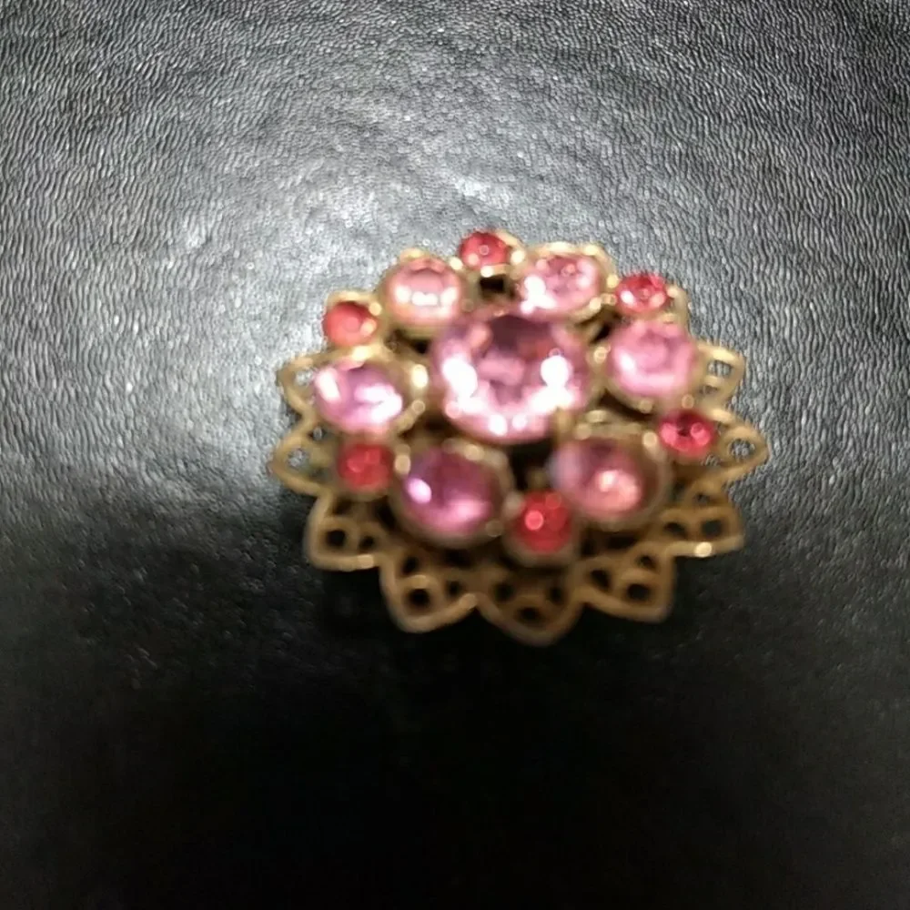 Gold tone flower pin with pink stones brooch